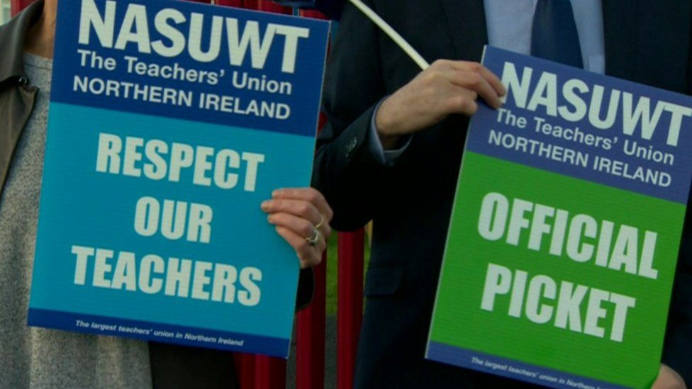 Striking teachers hold placards outside St Patrick's School in 2018.