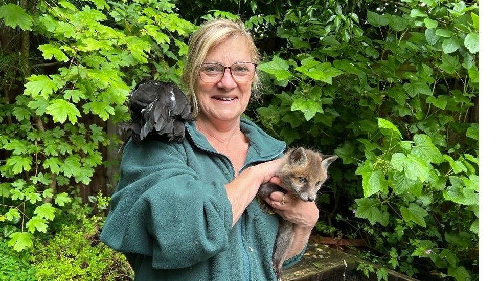 Sue Stubley posing with a fox