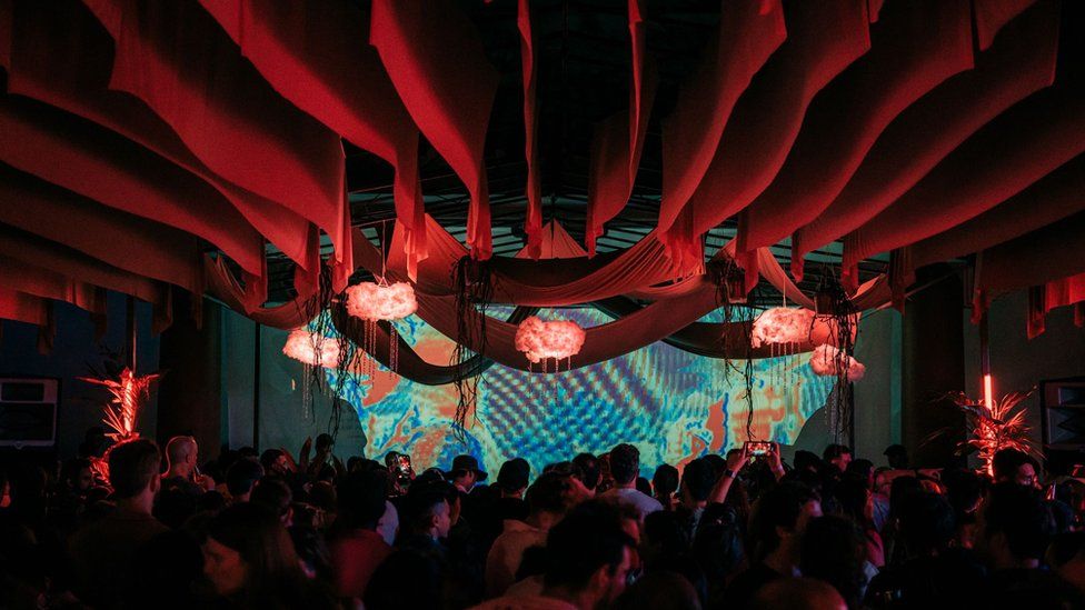 Lanterns and peach drapes hang over the dance crowd at the Haw Par rave