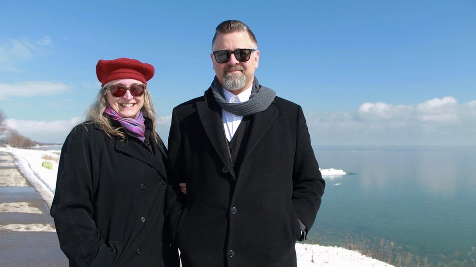 Tina and Jason Prigge stand in front of Lake Michigan