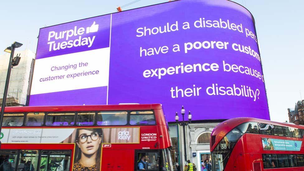 Electronic billboard explains Purple Tuesday at Piccadilly Circus in London