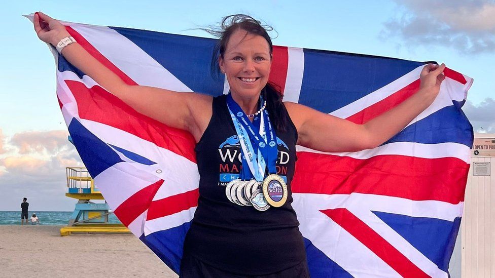 Sally Orange with GB flag and seven medals