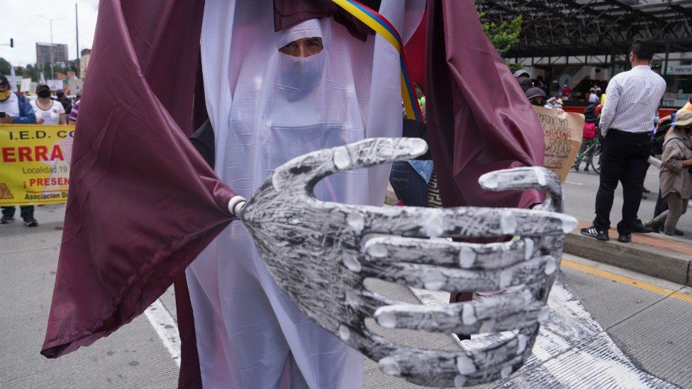Ramiro Velasco wears a costume at a demonstration in Bogota on May 12, 2021