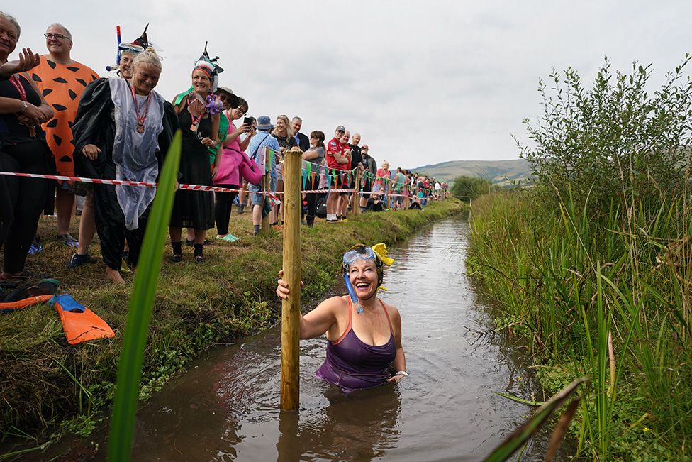 A competitor takes part in the World Bog Snorkelling Championships at Waen Rhydd peat bog in Llanwrtyd Wells