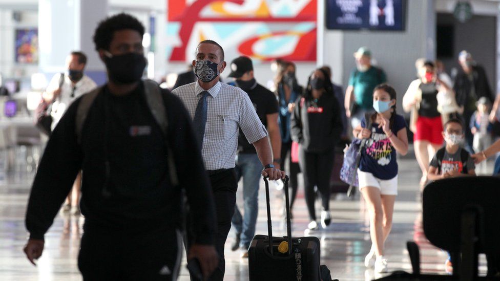 Passengers walk through the United Airlines terminal at George Bush Intercontinental Airport on May 11, 2020 in Houston, Texas