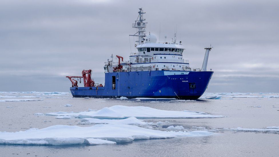 research vessel among icebergs