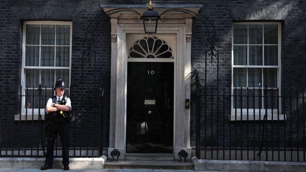A policeman standing outside 10 Downing Street