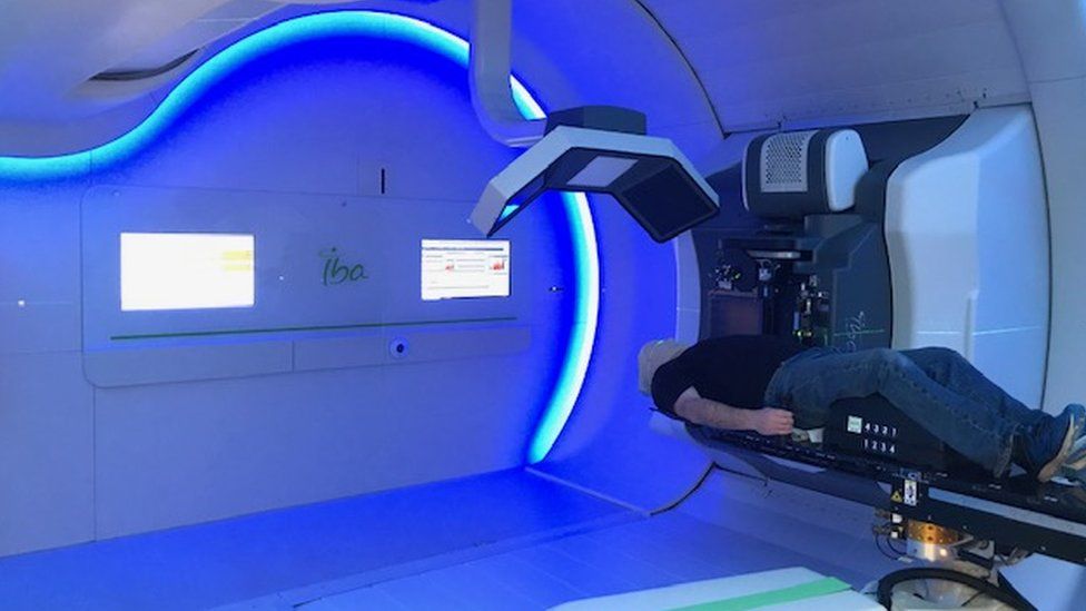 Nick Haves going into the proton beam therapy machine