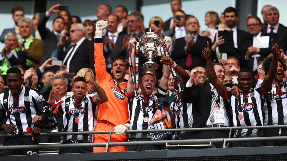 Grimsby's Craig Disley lifts the trophy as he celebrates the side's Vanarama Football Conference League Play Off Final win in 2016