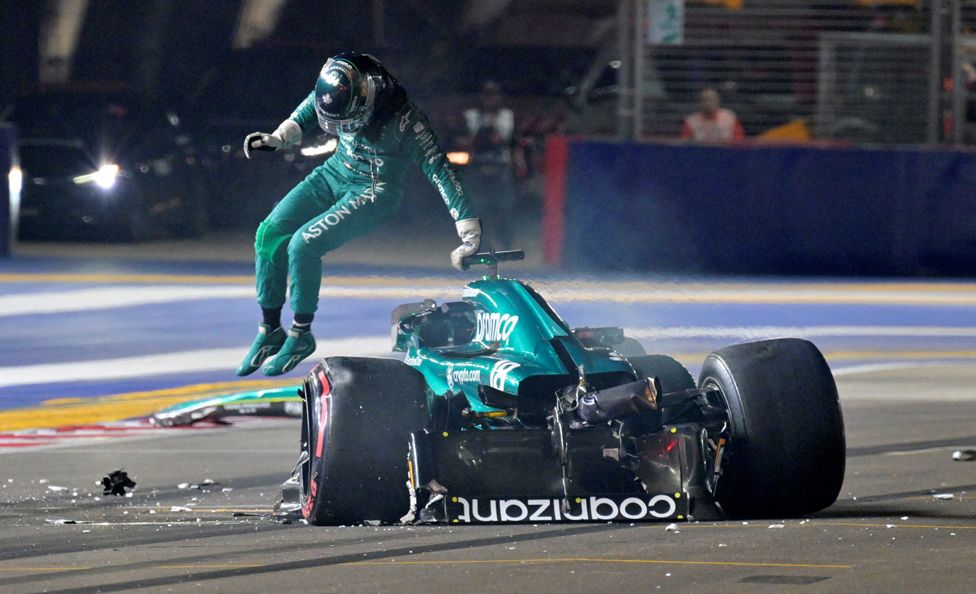 Lance Stroll of Canada and Aston Martin F1 Team climbs out of his car after crashing on track during qualifying ahead of the F1 Grand Prix of Singapore at Marina Bay Street Circuit on 16 September 2023