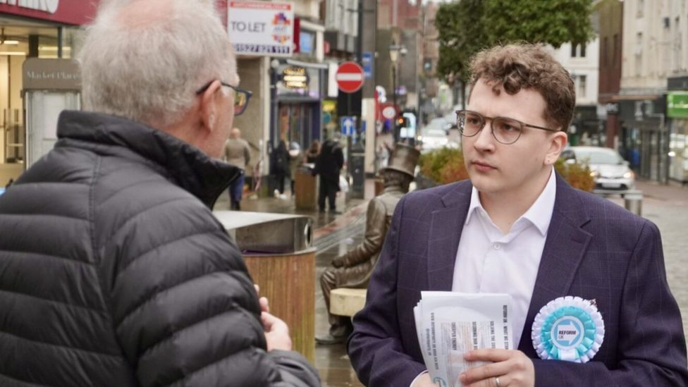 Man speaking to a Reform UK activist in Dudley