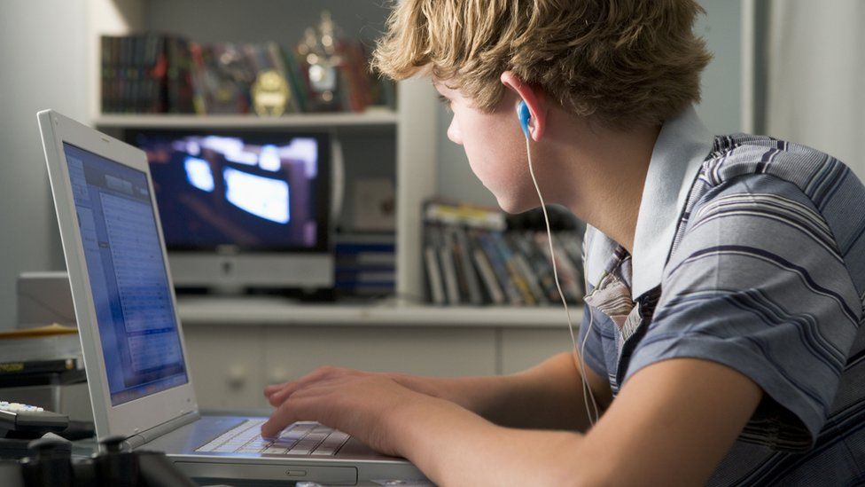 Teenage boy using a computer