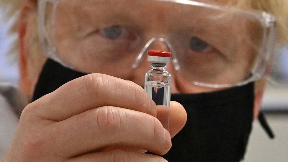 Boris Johnson holding a Covid vaccine