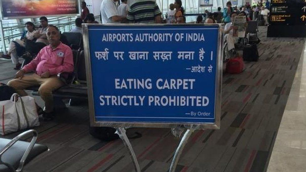 "Eating carpet strictly prohibited" sign at Indian airport