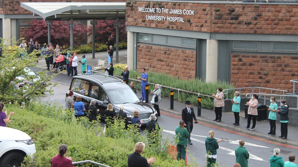 Well-wishers line the street as the funeral car carrying Mark Lowe drives slowly past
