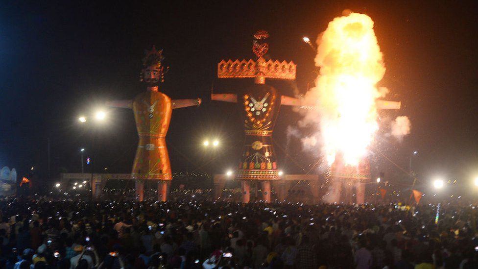 People watch the burning of an effigy of the Ravan on the occasion of Dussehra festival celebration at Durgiana Dussehra ground, on October 15, 2021 in Amritsar, India.