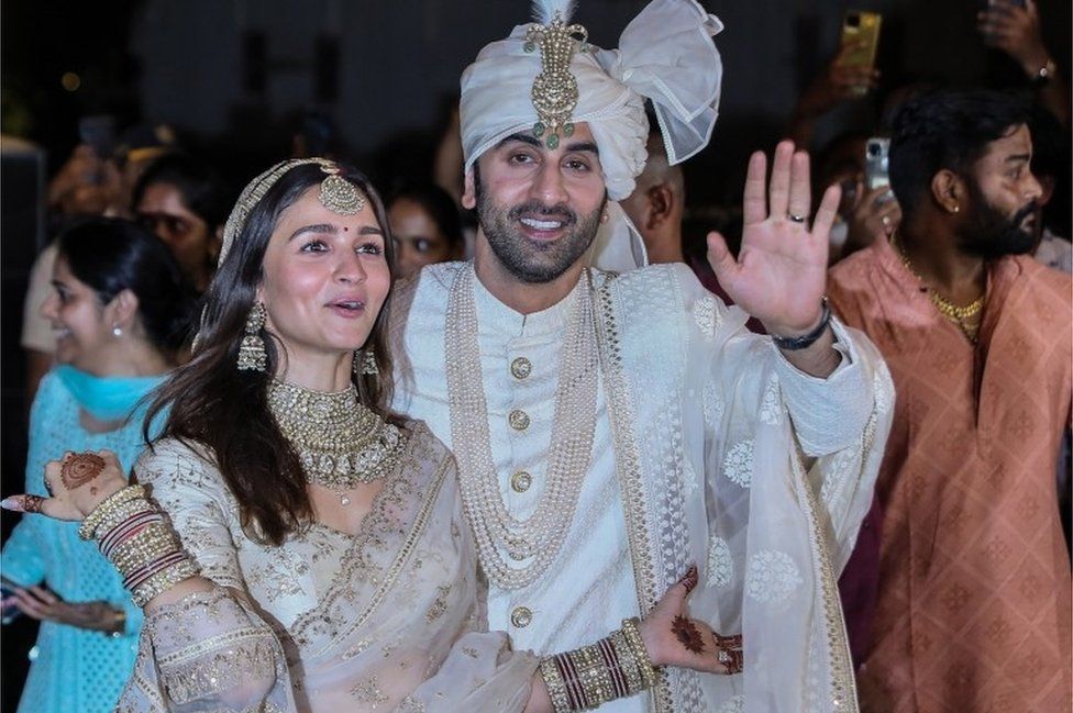 Bollywood actors Rabir Kapoor (R) and Alia Bhatt (L) pose for photos after their wedding at their residence in Mumbai, India, 14 April 2022.