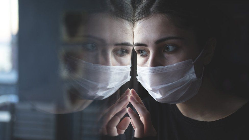 woman looking out of window