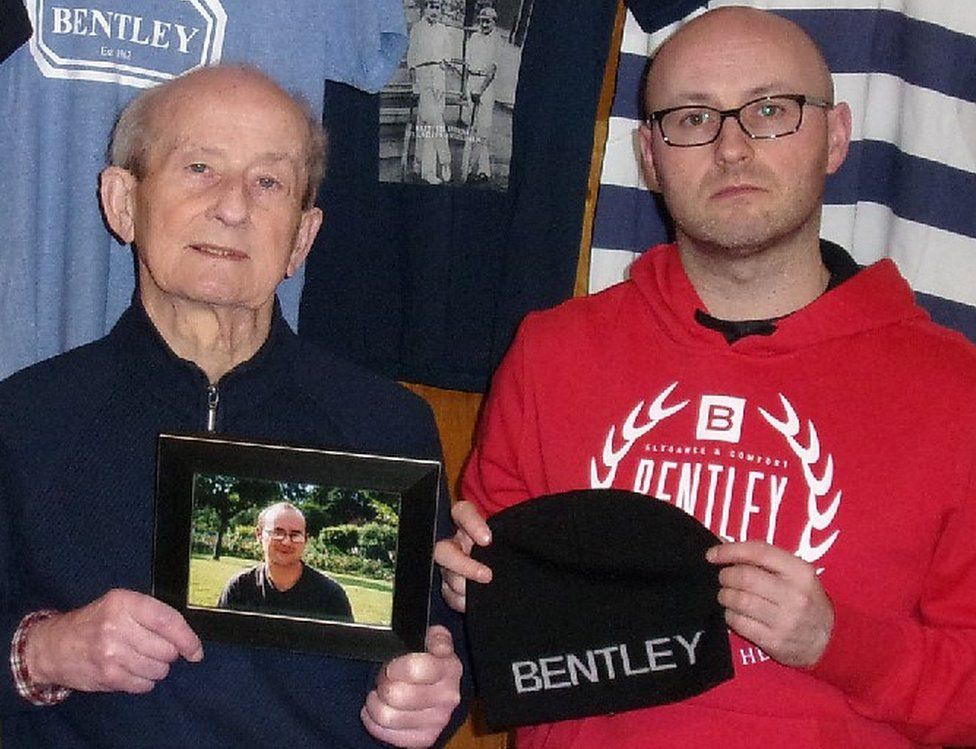 Robert and Chris Lees holding a photograph of Richard Lees