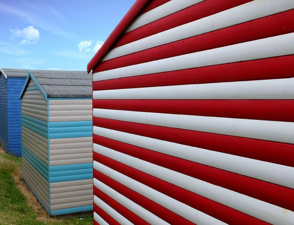 Red and blue coloured beach huts