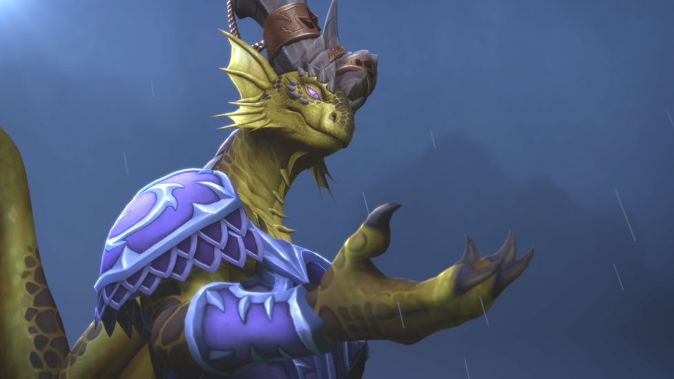 A lizard-like humanoid creature stands in the rain, looking slightly evil, with what looks like a volcano faintly visible in the background. He's wearing purple body armour with light blue decorations around the borders. He has green, scaly skin with pink/purple eyes. He's wearing a headpiece which resembles the glove from a knight's suit of armour. His clawed hand is held out, upturned, in front of him, as if trying to catch raindrops.