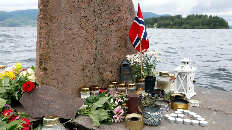 Flowers and candles are placed on the shore opposite to the Utoeya Island, Norway, 24 July 2011.