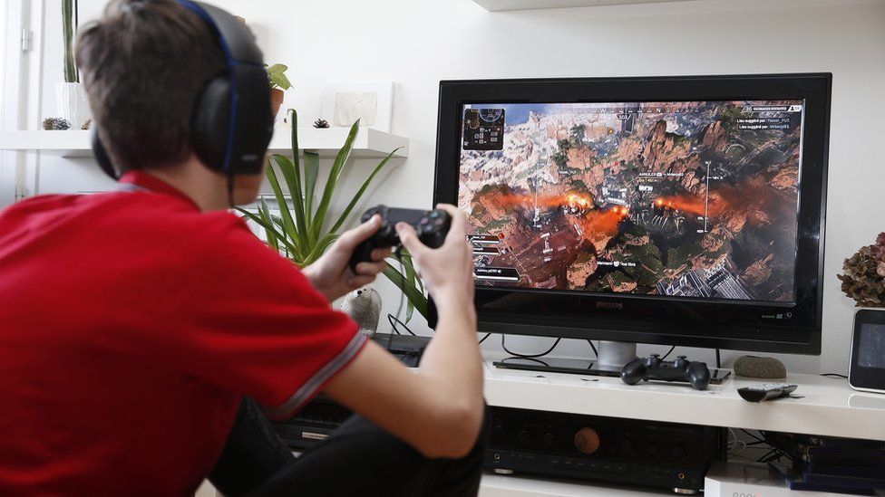 Teenagers playing a video game