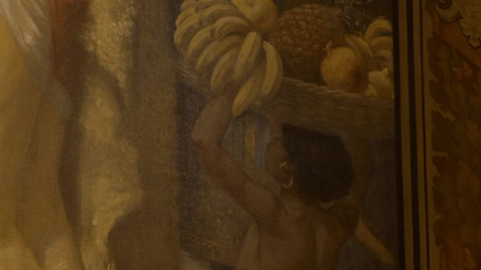 Close up of mural where a black boy is seen offering gifts to Britain