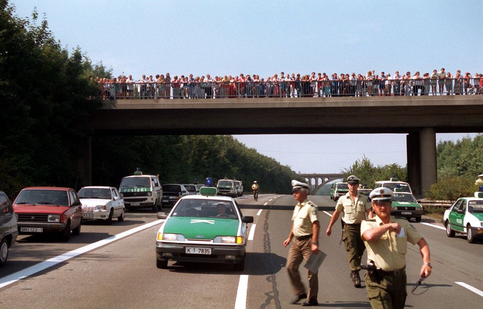 Crowds gathered on a bridge over the autobahn in the aftermath of the shootout