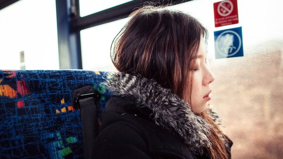 A girl sleeping on the bus
