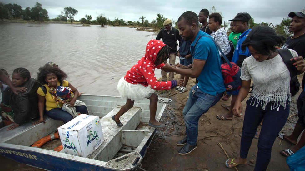 Families affected by Cyclone Idai get off a boat in Beira, Mozambique