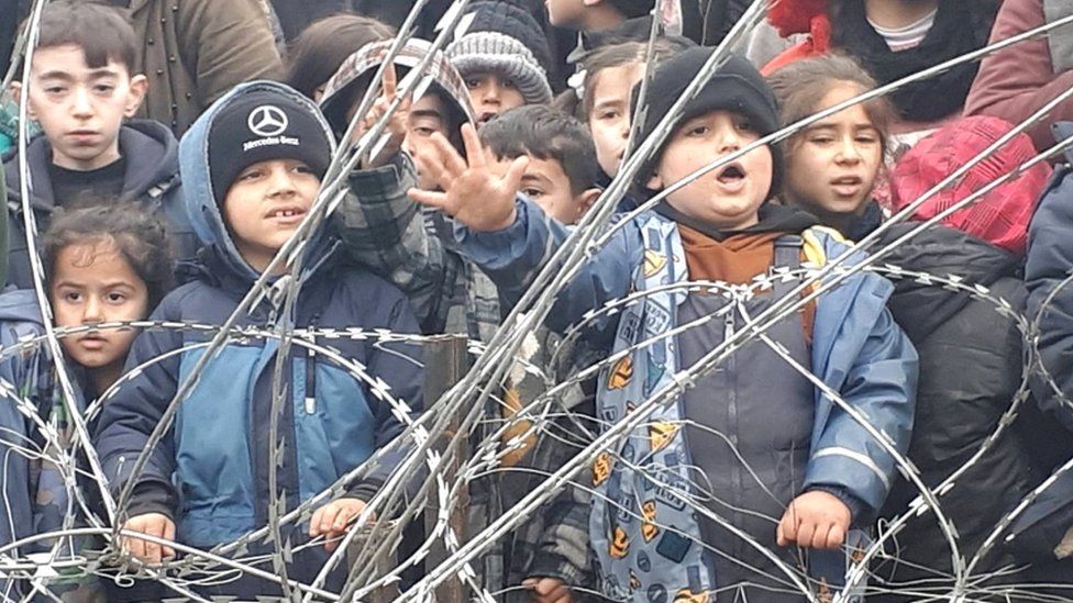 This Polish interior ministry screengrab shows children behind the razor-wire fence