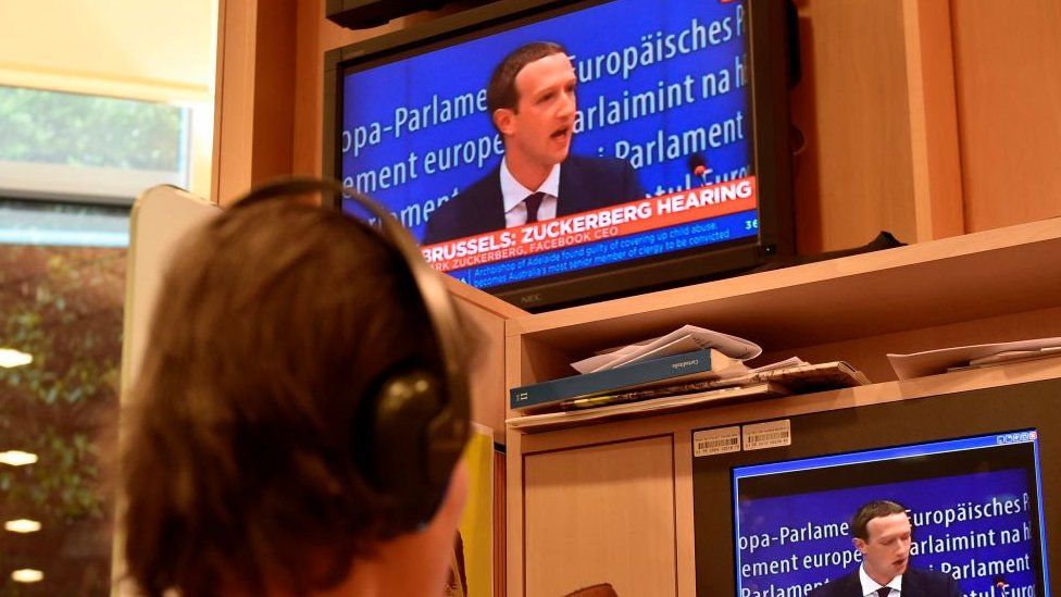 Facebook founder Mark Zuckerberg on a television during his testimony to EU lawmakers May 2018