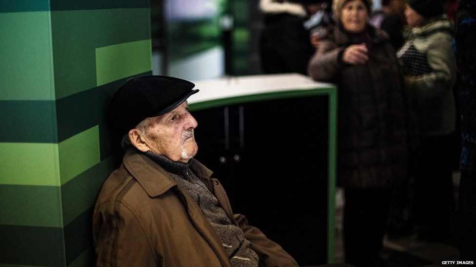 A man waits to receive his pension paid in Russian rouble notes in the eastern Ukrainian city of Donetsk on 1 April 2015.