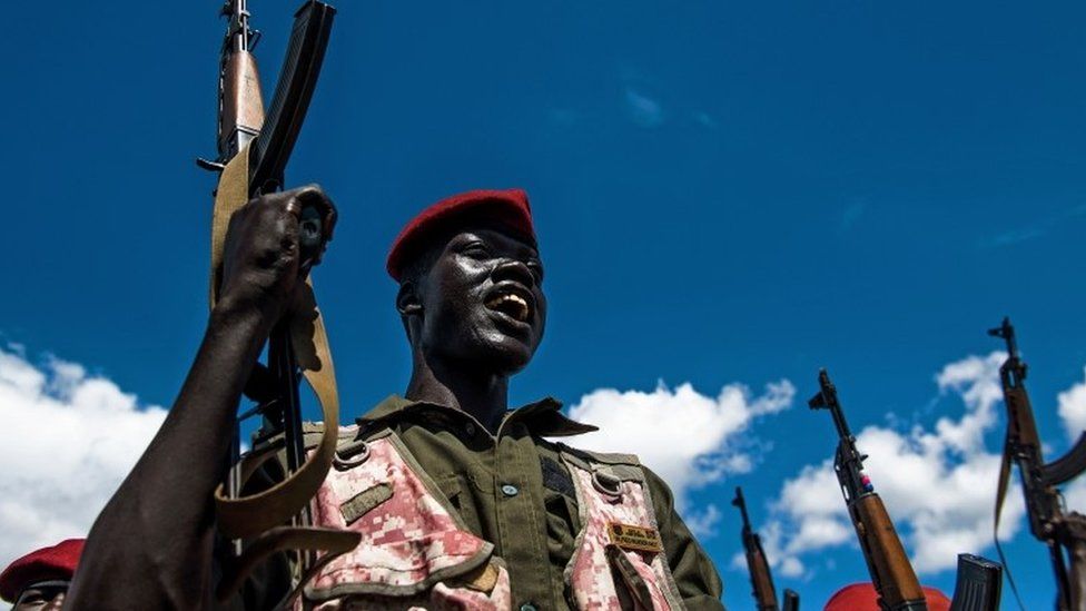 A Sudan People's Liberation Army (SPLA) soldier holds up a gun at a containment site outside Juba on April 14, 2016