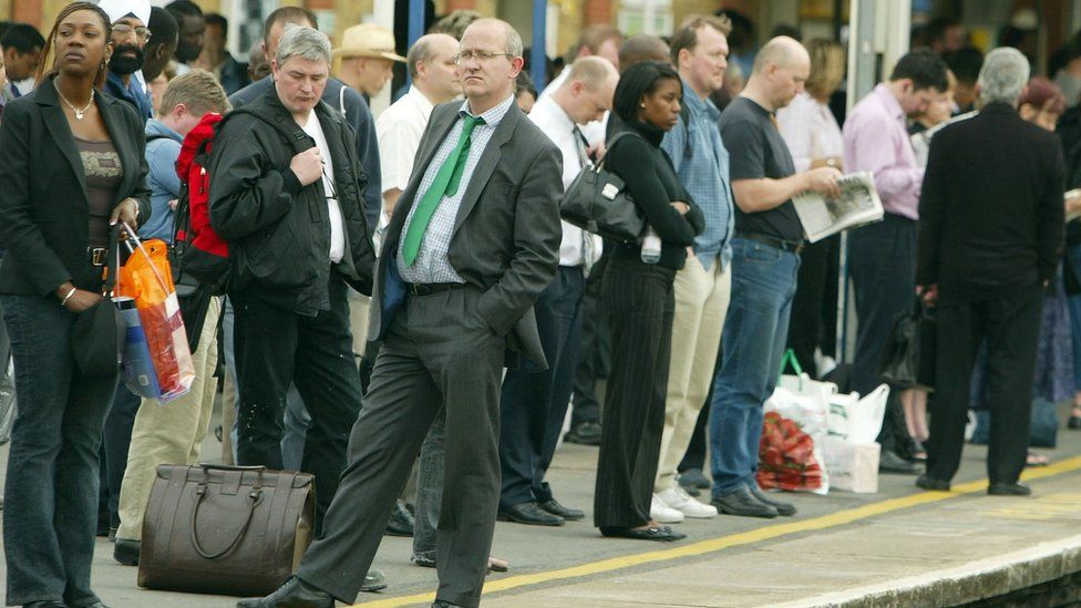 Passengers wait on an outdoor platform