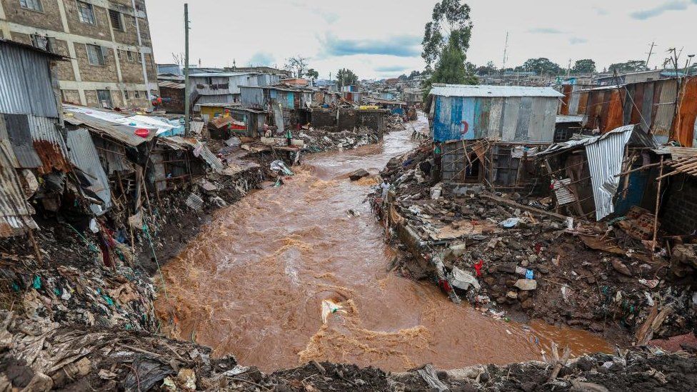 People inspect damaged houses at an area flooded by the Gitathuru river water, a day after it overflowed and broke its banks due to heavy rainfall damaging surrounding neighborhoods, in the Mathare slums, Nairobi, Kenya, 25 April 2024