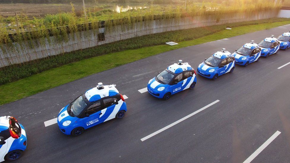 A row of Baidu driverless cars being tested on a track.