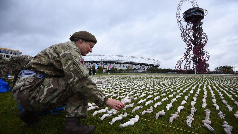 A soldier helps set out the Shrouds of the Somme