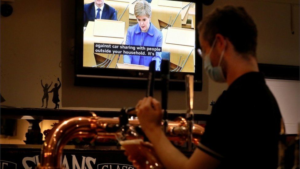 Bar staff in Sloan's in Glasgow watch First Minister Nicola Sturgeon making her statement