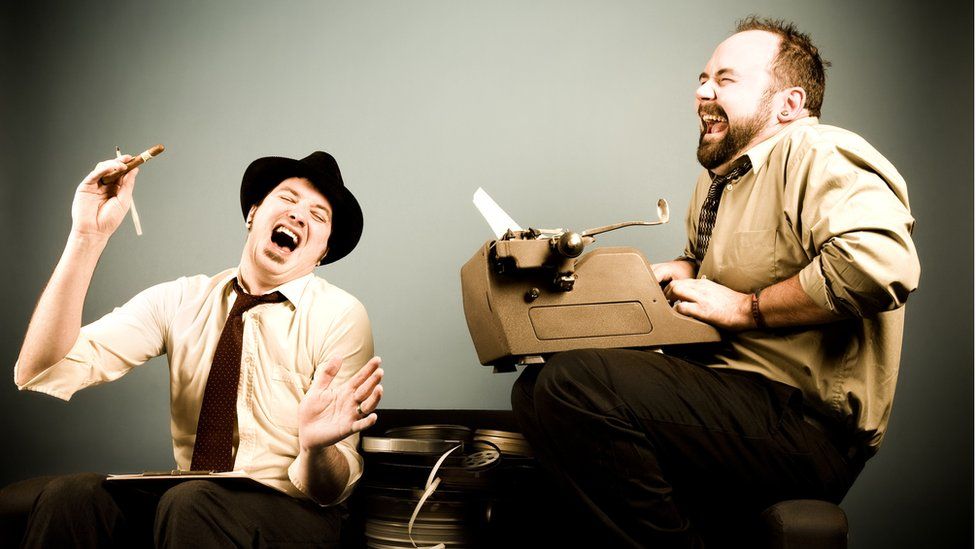 Two men laughing in glee