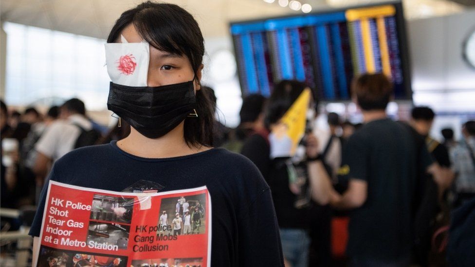 A woman wearing an eye patch as a protest at Hong Kong airport