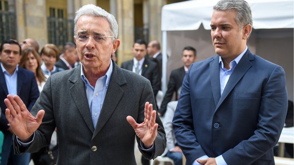 Alvaro Uribe (L) speaks to the press next to presidential candidate Ivan Duque, after casting his vote at a polling station during parliamentary elections in Colombia, in Bogota on March 11, 2018. C