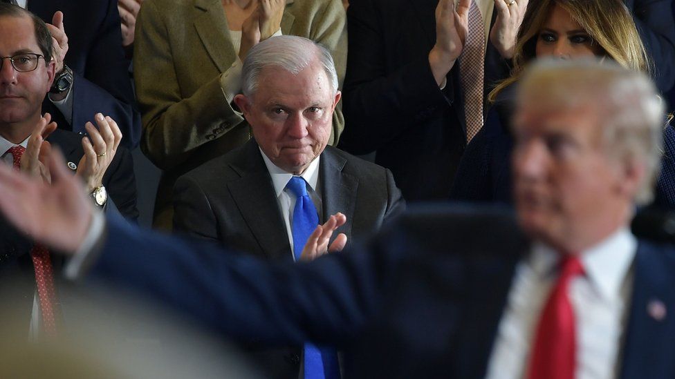 Attorney General Jeff Sessions (C) and First Lady Melania Trump (R) applaud during a speech by US President Donald Trump, 19 March 2018