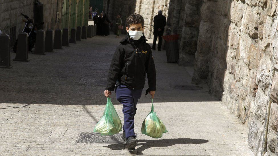 boy in jerusalem wearing mask