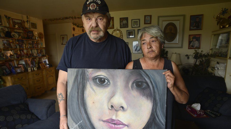 Joe and Thelma Favel display a framed painting of their niece, Tina Fontaine, who was murdered and her body dumped in the Red River