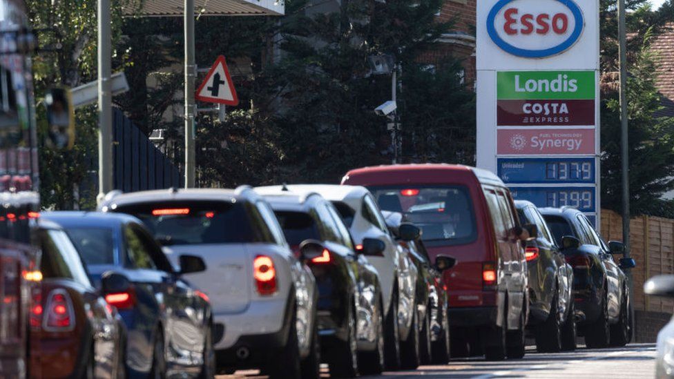 A queue forms for an Esso petrol station on September 24, 2021 in London