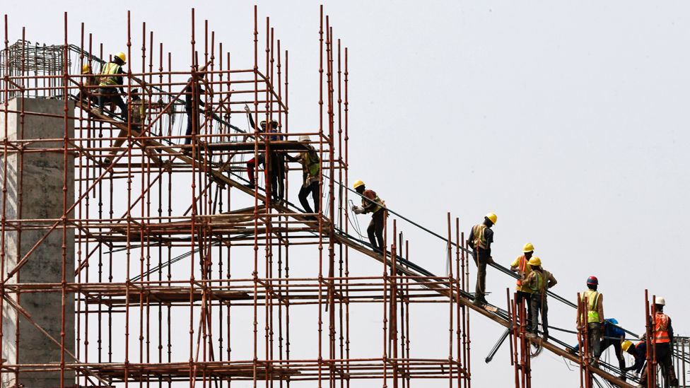 Construction workers stand on scaffolding in Abuja, Nigeria - Thursday 12 March 2020