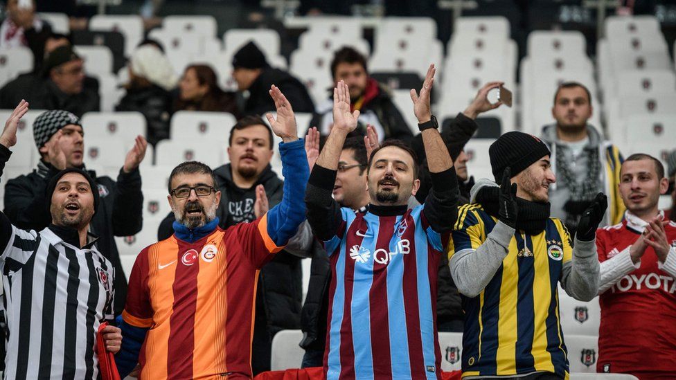 Besiktas, Fenerbahce, Galatasaray and Trabzon"s supporters cheer prior to the Ziraat Turkish Cup football match between Besiktas and Kayserispor on December 14, 2016