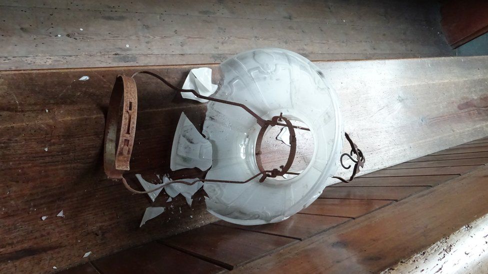 A damaged lamp at St Mary's Church, Llanfair Kilgeddin